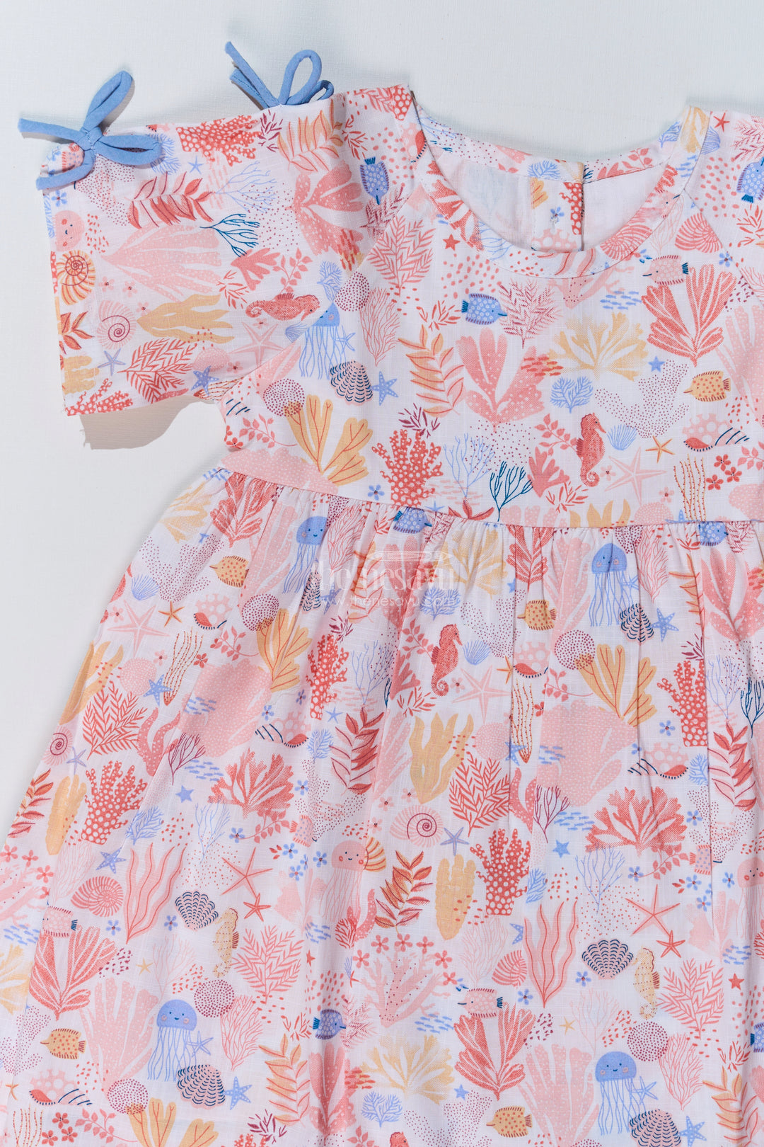 Baby Girls Peach Frock with Ocean-Inspired Print and Tie-Up Sleeves for a Charming Look