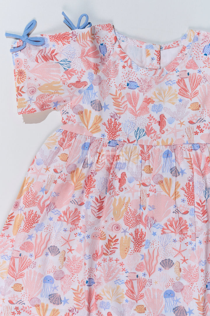 Baby Girls Peach Frock with Ocean-Inspired Print and Tie-Up Sleeves for a Charming Look