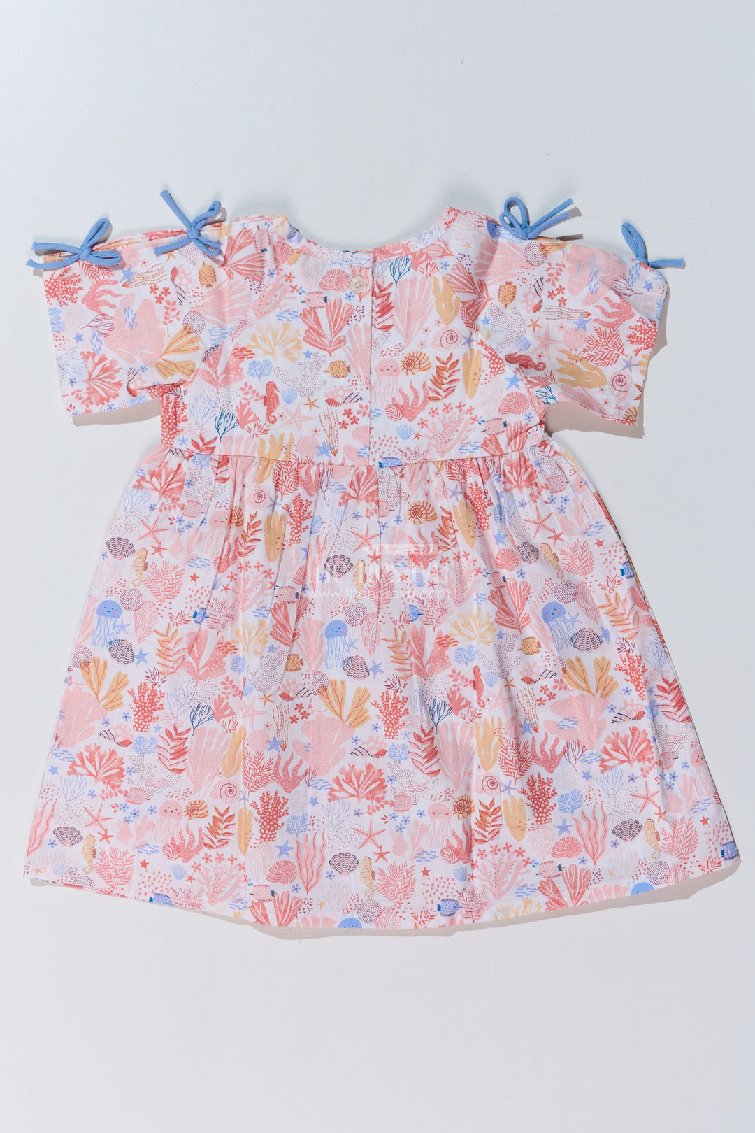 Baby Girls Peach Frock with Ocean-Inspired Print and Tie-Up Sleeves for a Charming Look