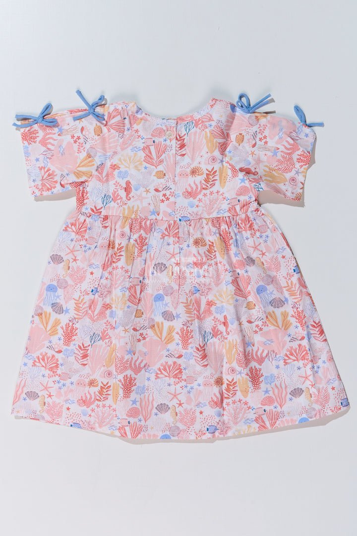 Baby Girls Peach Frock with Ocean-Inspired Print and Tie-Up Sleeves for a Charming Look