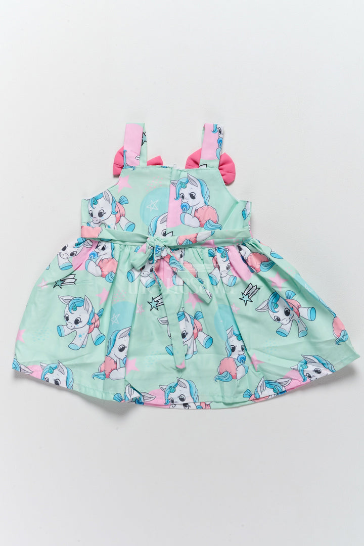 The Nesavu Baby Fancy Frock Baby Fancy Poly Crepe Simple Frock with Unicorn Prints and Pink Bow Accents Nesavu Nesavu Baby Fancy Poly Crepe Simple Frock Unicorn Prints Pink Bow Accents