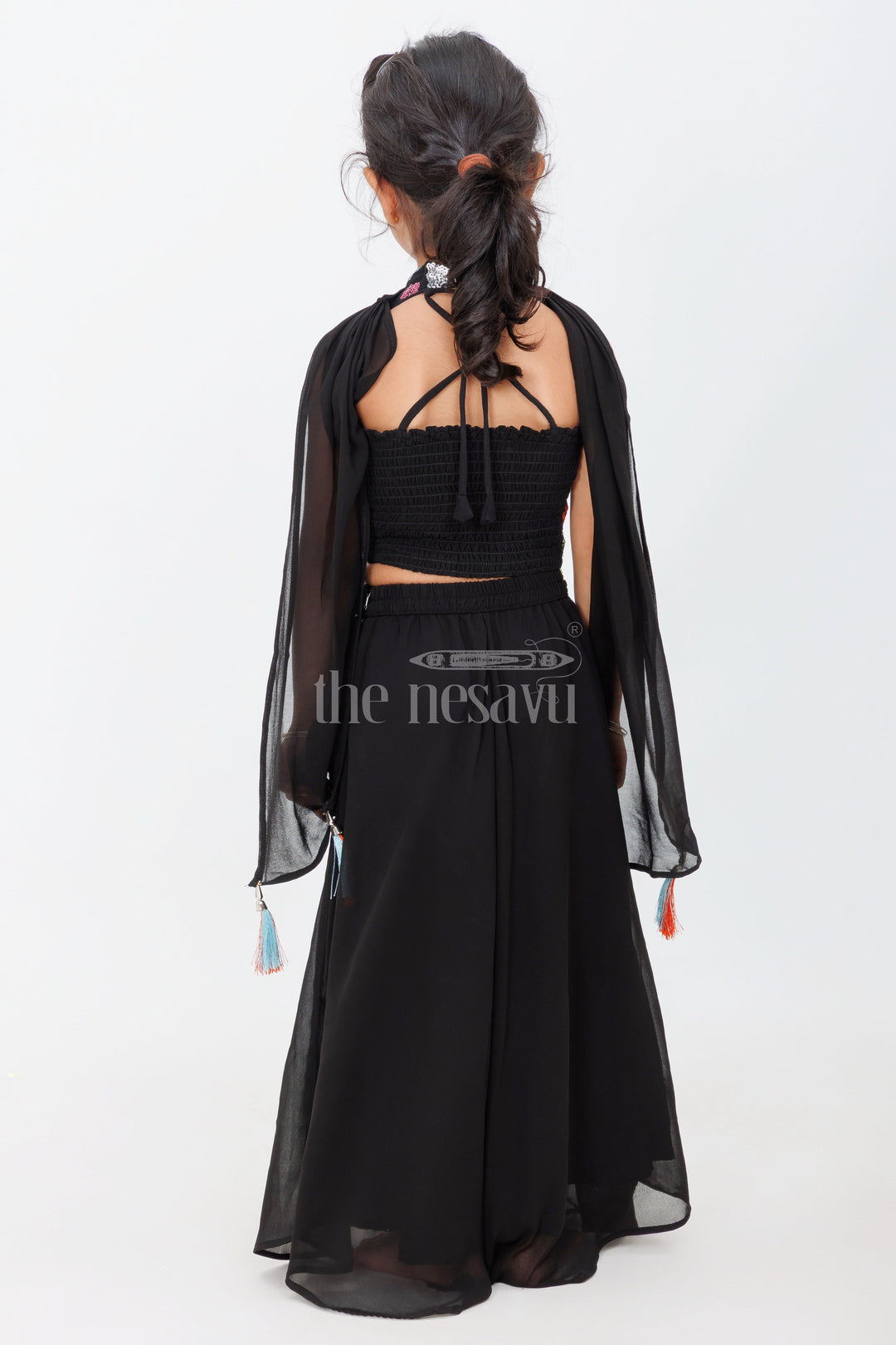 The Nesavu Girls Sharara / Plazo Set Black Halter-Neck Girls Sharara Set with Floral Embroidery and Belted Waist for Semi-Formal Occasions Nesavu Nesavu Black Girls Sharara Set Floral Embroidered Halter-Neck Top Belted Skirt Special Events