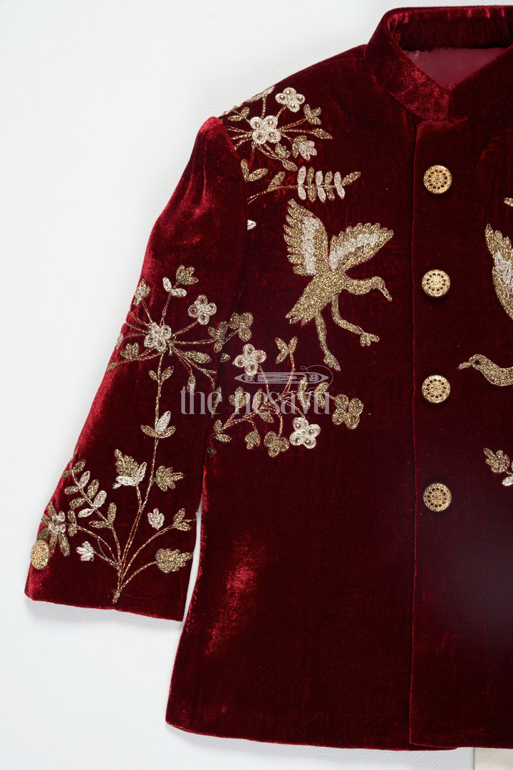 The Nesavu Boys Sherwani Boys Maroon Sherwani Kurta with Intricate Golden Velvet Embroidery and Cream Trousers Nesavu Nesavu Boys Maroon Sherwani Kurta Velvet Golden Embroidery Cream Trousers