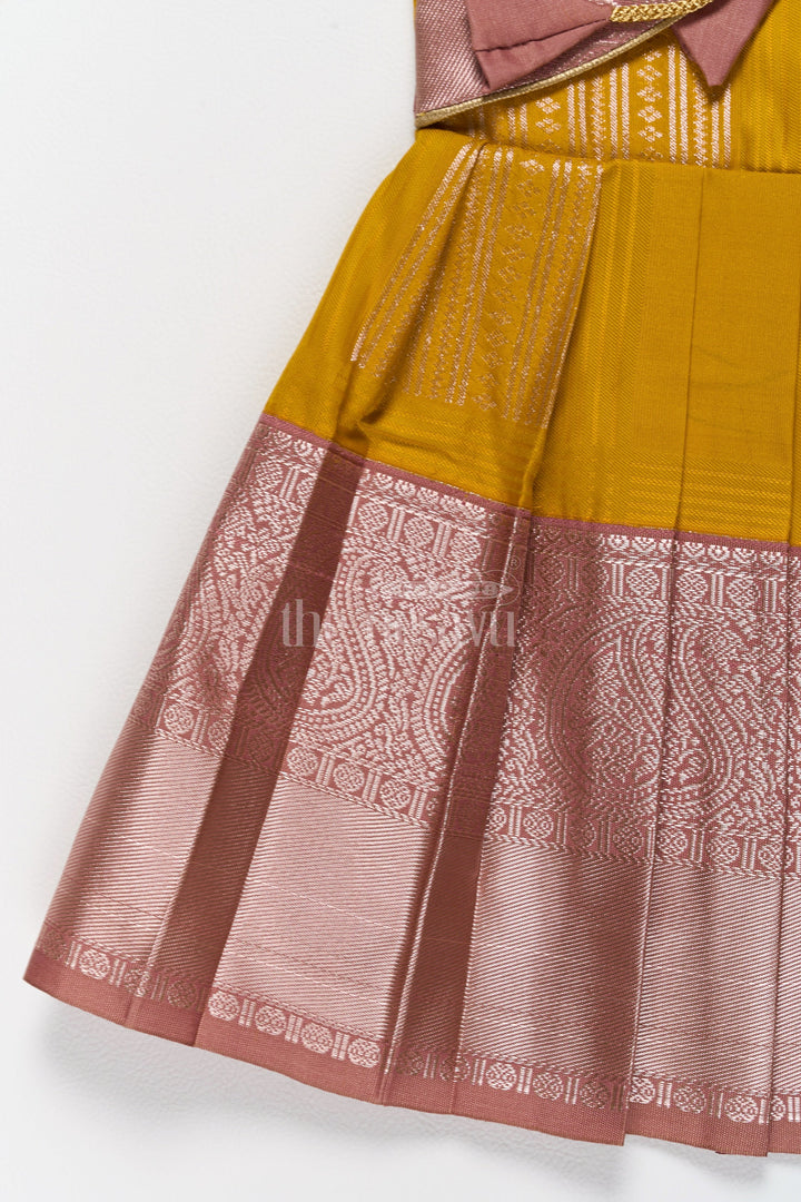 The Nesavu Girls Kanchi Silk Frock Charming Yellow and Brown Girls Kanchi Silk Frock with Traditional Brocade for Pongal Nesavu Yellow Brown Girls Kanchi Silk Frock Pongal Celebrations Nesavu