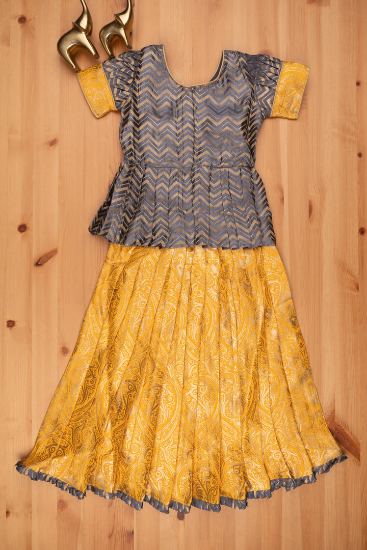 The Nesavu Pattu Pavadai Chic Zig Zag Gray Peplum Top with Banarasi Designer Pattu Pavadai: Festive Delight for Girls Nesavu Banarasi Designer Yellow Pattu Pavadai | Pattu Pavadai New Model | The Nesavu