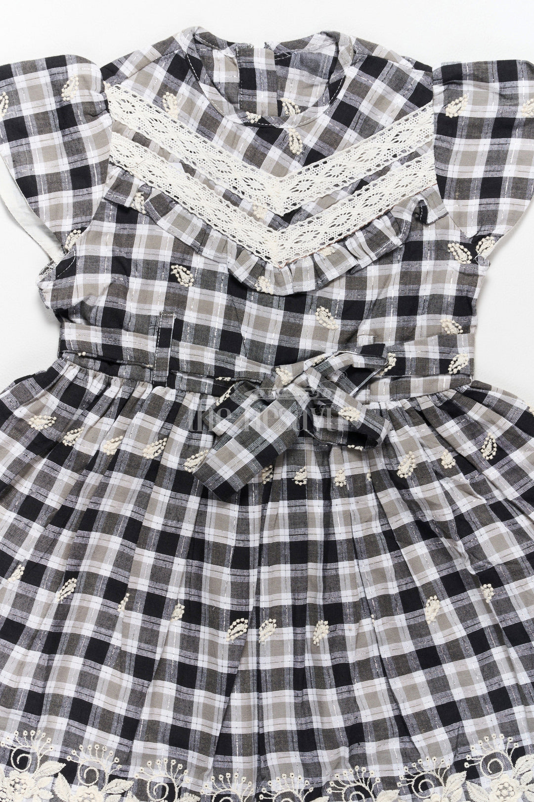 The Nesavu Girls Cotton Frock Classic Black and White Checked Cotton Frock with Lace Hem New Frock Model Nesavu Nesavu Black White Checked Hakoba Cotton Frock Lace Neckline Embroidered Hem