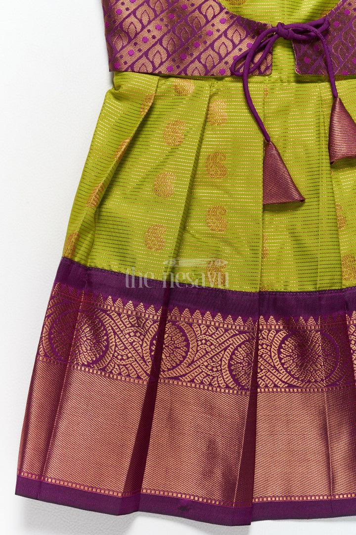 The Nesavu Girls Kanchi Silk Frock Elegant Girls Kanchi Silk Frock with Intricate Purple Border for Pongal Dressing Nesavu Pongal Special Girls Kanchi Silk Frock Lime Green Purple Design Nesavu