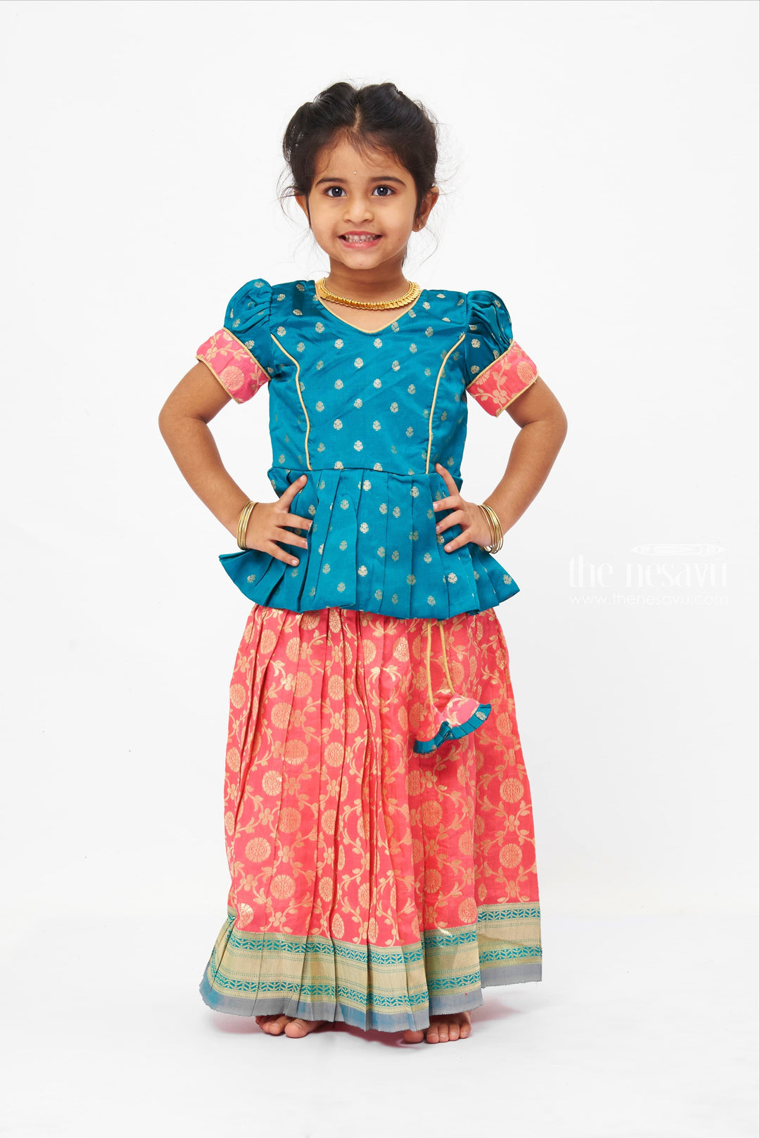 The Nesavu Pattu Pavadai Floral Butta Green Peplum Blouse combined with Banarasi Pink Pattu Pavadai Traditional Festive Wear Nesavu Banaras Designer Pattu Pavadai | Silk Skirt With Blouse for Girls | the Nesavu