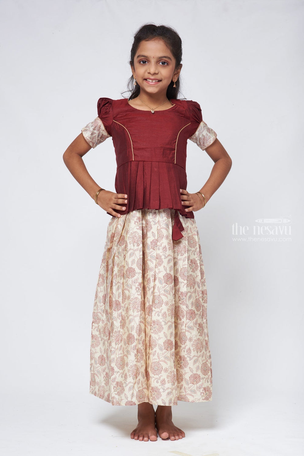 The Nesavu Pattu Pavadai Floral Printed Pleated Beige Skirt with Box Pleated Brown Jacquard Silk Blouse for Girls Nesavu Latest Pattu Pavadai Designs | Girls Pattu Langa | The Nesavu