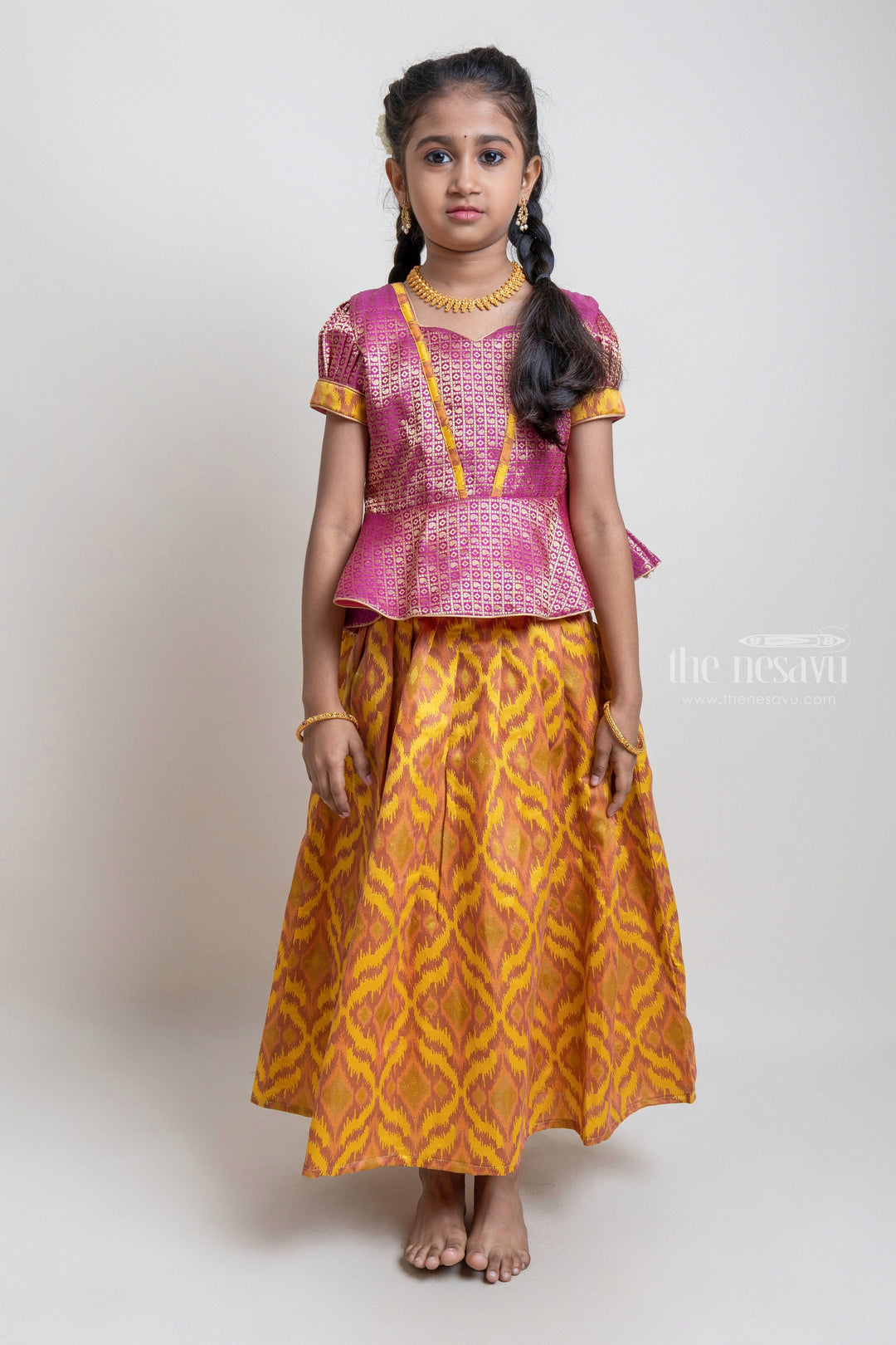 The Nesavu Pattu Pavadai Gorgeous Pink Floral Designed Silk Blouse With Woven Ikat Design Ziz-Zag Pattu Pavadai For Girls Nesavu Traditional Wear For Girls | Latest Pattu Pavadai | The Nesavu