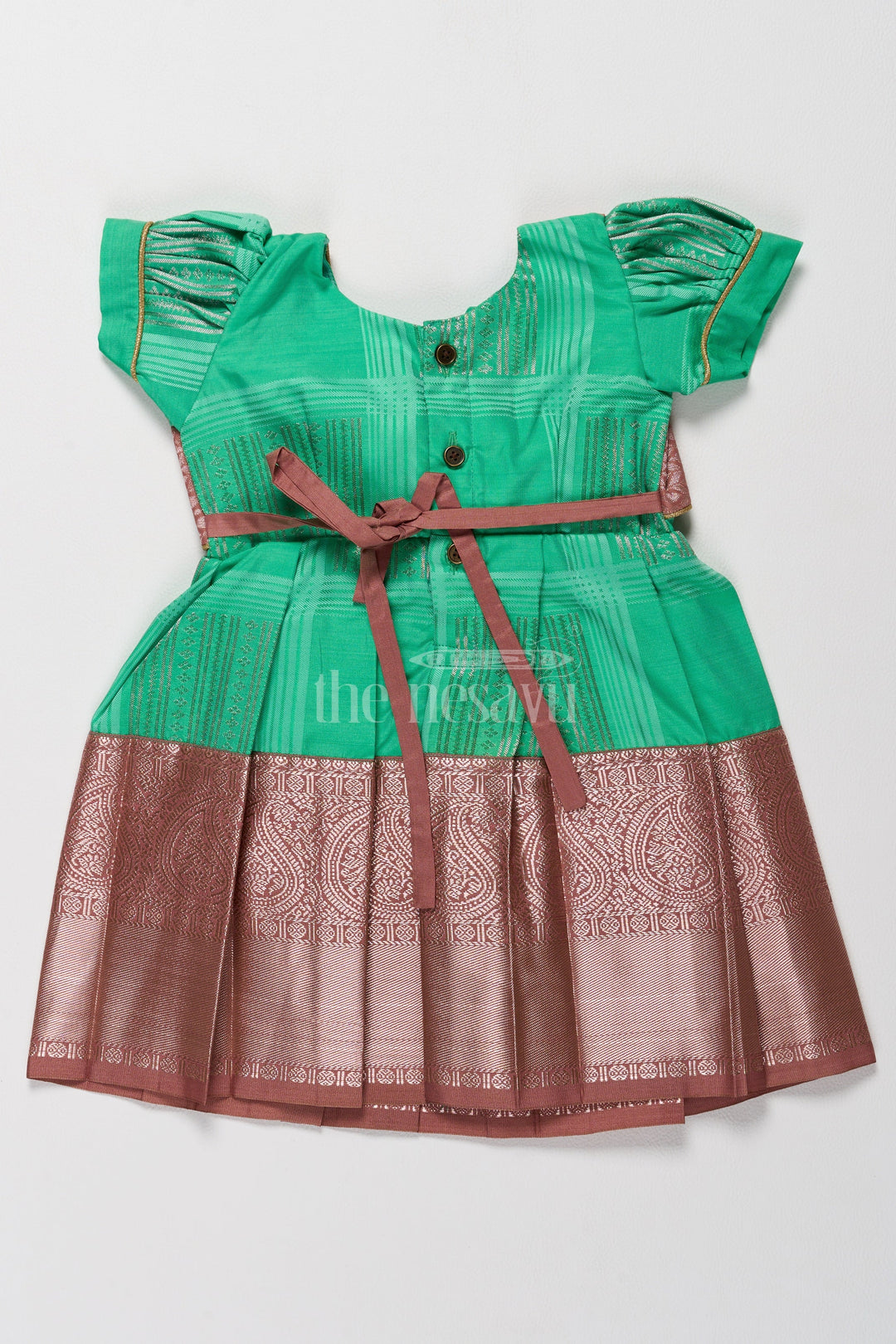 The Nesavu Girls Kanchi Silk Frock Green and Bronze Pattu Pavadai Frock Model for Girls with Golden Lace Nesavu Nesavus Green Bronze Pattu Pavadai Frock Model Girls Elegant Cape Design