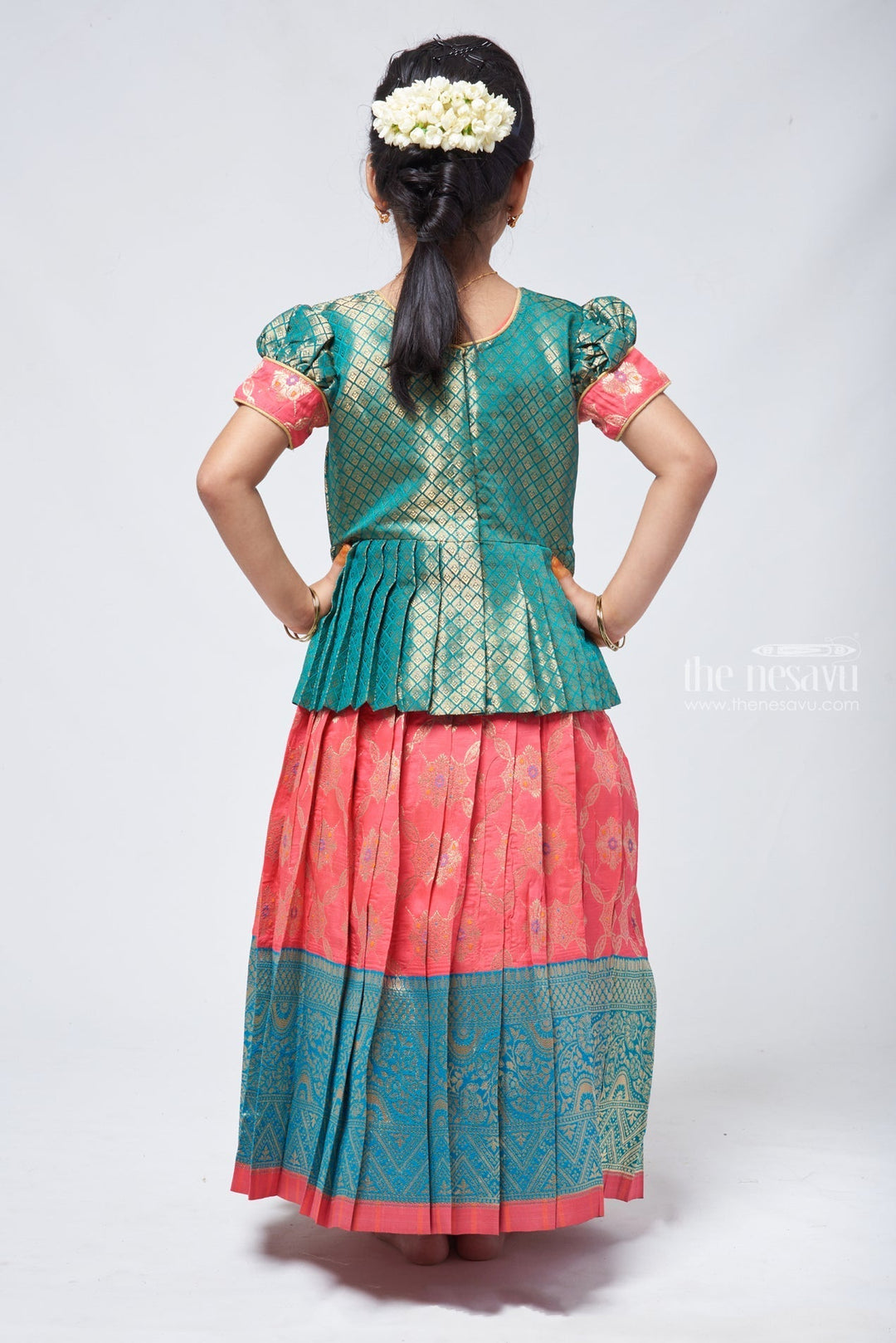 The Nesavu Pattu Pavadai Lavish Brocade Peplum Green Blouse with Zari Banarasi Pink Skirt: Classic Silk Beauty for Girls Nesavu Zari Banarasi Pavadai chattai | Designer Pattu Pavadai | The Nesavu