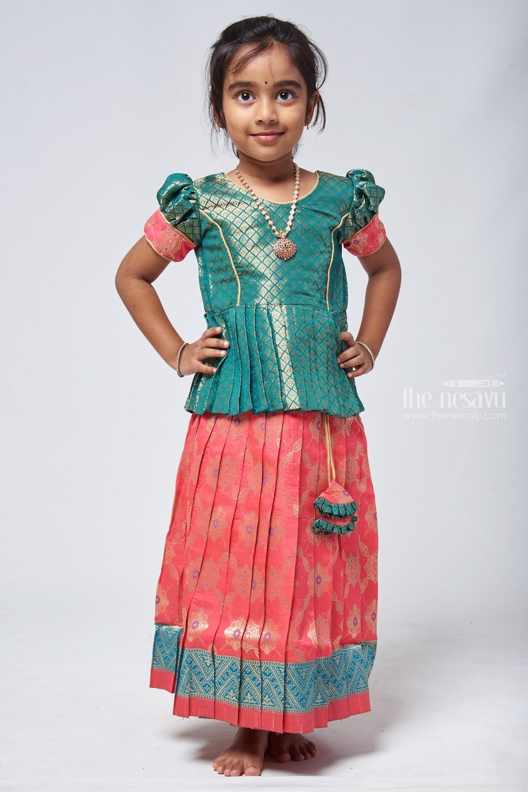 The Nesavu Pattu Pavadai Lavish Brocade Peplum Green Blouse with Zari Banarasi Pink Skirt: Classic Silk Beauty for Girls Nesavu Zari Banarasi Pavadai chattai | Designer Pattu Pavadai | The Nesavu