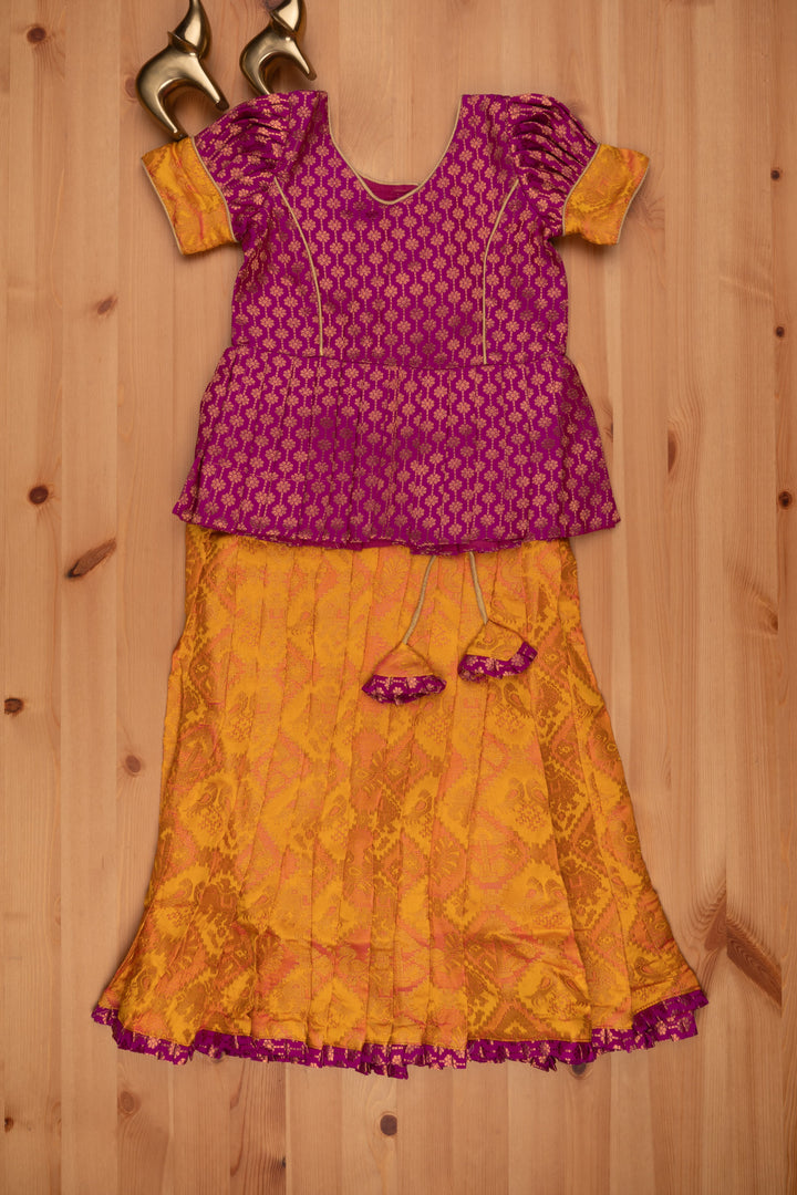 The Nesavu Pattu Pavadai Lavish Brocade Purple Peplum Top with Banarasi Yellow Silk Pavadai: South Indian Elegance Nesavu Pattu Pavadai with peplum blouse | Pattu Pavadai Latest Design | The Nesavu