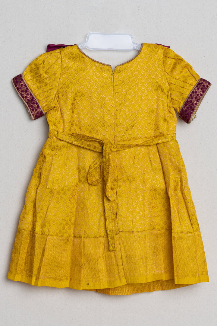 The Nesavu Girls Kanchi Silk Frock Mango Yellow with Deep Purple Semi Banarasi Silk / Pattu Frock For Kids Girls Nesavu Floral Purple and Yellow Semi-Silk Frock for Girls | Zari with Floral Brocade Designer Purple Yoke | The Nesavu