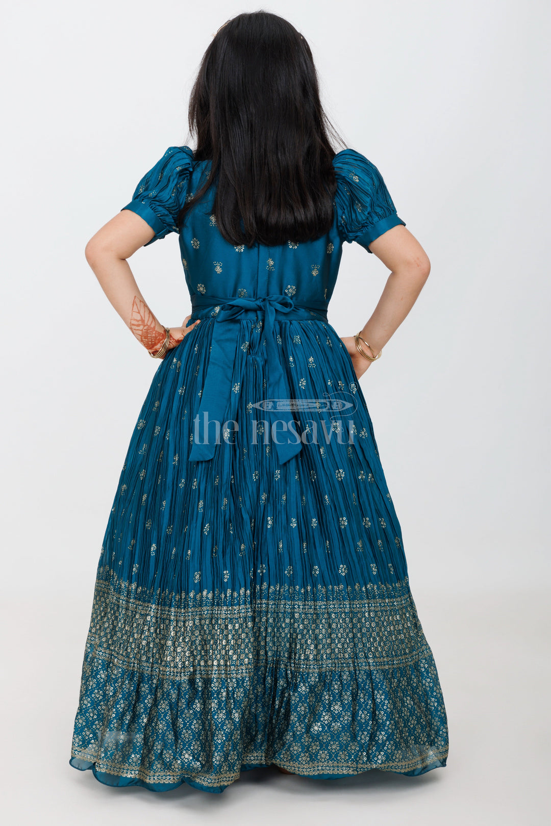 The Nesavu Girls Silk Gown Teal Girls Grand Silk Gown with Puff Sleeves and Foil Print for Special Functions Nesavu Nesavu Teal Girls Silk Gown Puff Sleeves Gold Embroidery Grand Occasions