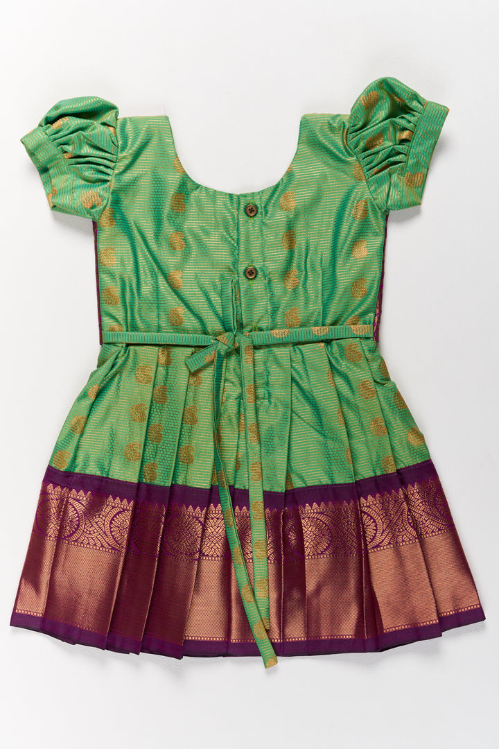 The Nesavu Girls Kanchi Silk Frock Vibrant Girls Kanchi Silk Frock in Green with Traditional Purple Borders for Pongal Fashion Nesavu Green Purple Girls Kanchi Silk Frock Pongal Nesavu