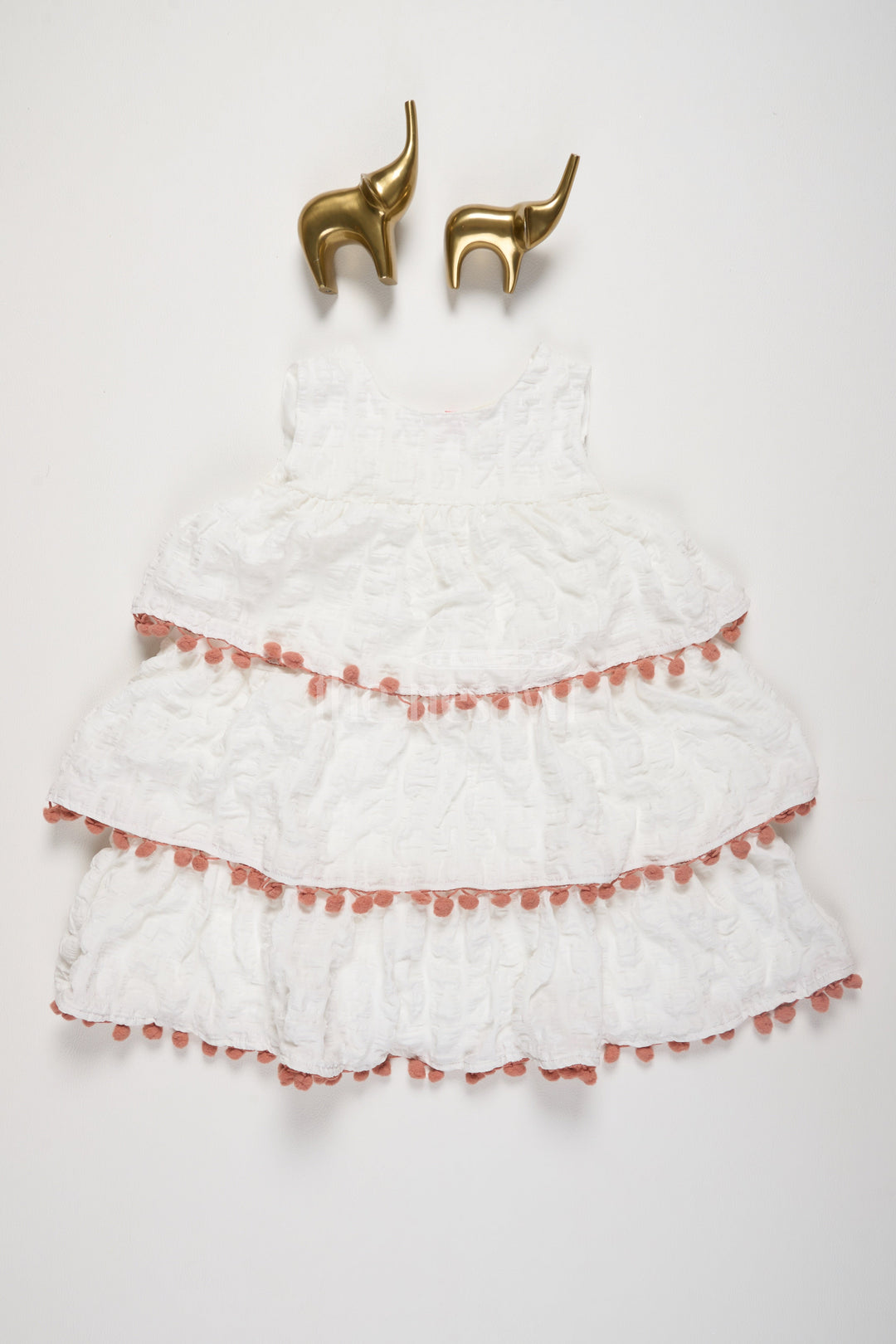 The Nesavu Girls Fancy Frock White-Tiered Girls Fancy Frock with Peach Pom-Pom Trim and Textured Design for Special Occasions Nesavu 16 (1Y) / White BFJ657C-16 Nesavu White-Tiered Fancy Frock Girls Peach Pom-Pom Trim Textured Layers Special Events