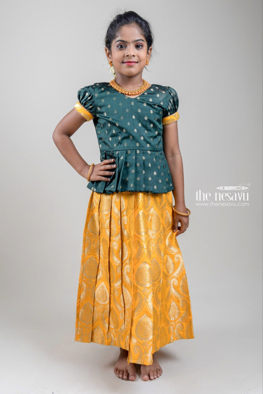 The Nesavu Pattu Pavadai Zari Butta Printed Green Silk Peplum Blouse with Knife Pleated Yellow Pattu Pavadai for Girls Nesavu Zari Butta Printed Green Silk Peplum Blouse with Knife Pleated yellow Pattu Pavadai for Girls | Shop at The Nesavu