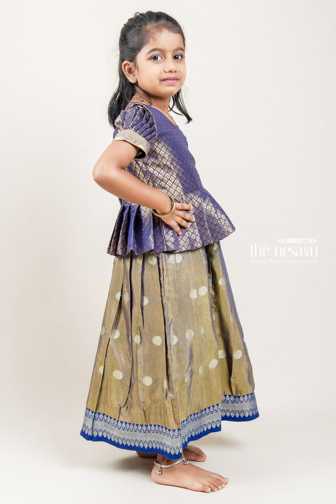 The Nesavu Pattu Pavadai Zari Designer Navy Silk Peplum Blouse with Knife Pleated Beige Silk Skirt for Girls Nesavu Zari Designer Navy Silk Peplum Blouse with Knife Pleated Blue Silk Skirt for Girls | Shop at The Nesavu