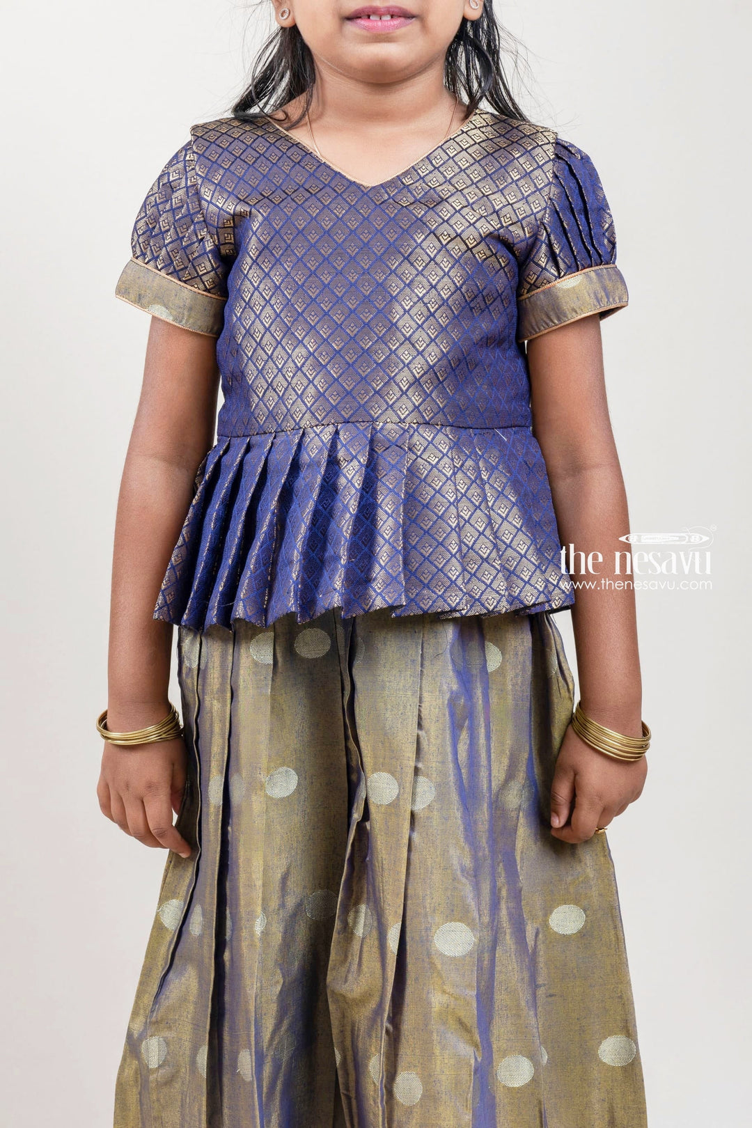 The Nesavu Pattu Pavadai Zari Designer Navy Silk Peplum Blouse with Knife Pleated Beige Silk Skirt for Girls Nesavu Zari Designer Navy Silk Peplum Blouse with Knife Pleated Blue Silk Skirt for Girls | Shop at The Nesavu