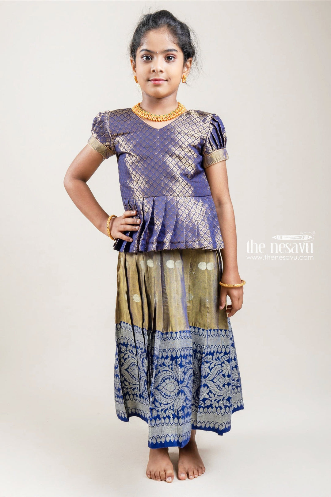 The Nesavu Pattu Pavadai Zari Designer Navy Silk Peplum Blouse with Knife Pleated Beige Silk Skirt for Girls Nesavu Zari Designer Navy Silk Peplum Blouse with Knife Pleated Blue Silk Skirt for Girls | Shop at The Nesavu