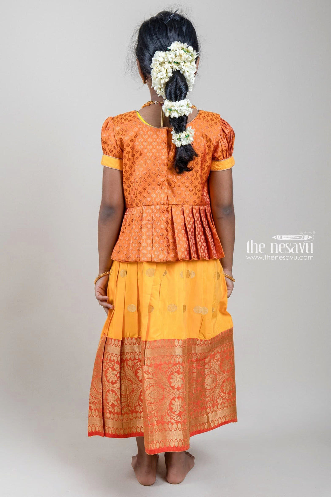 The Nesavu Pattu Pavadai Zari Floral Designer Brown Silk Peplum Blouse with Knife Pleated Yellow Silk Skirt for Girls Nesavu Zari Floral Designer Yellow Silk Peplum Blouse with Knife Pleated Yellow Silk Skirt for Girls | Shop at The Nesavu