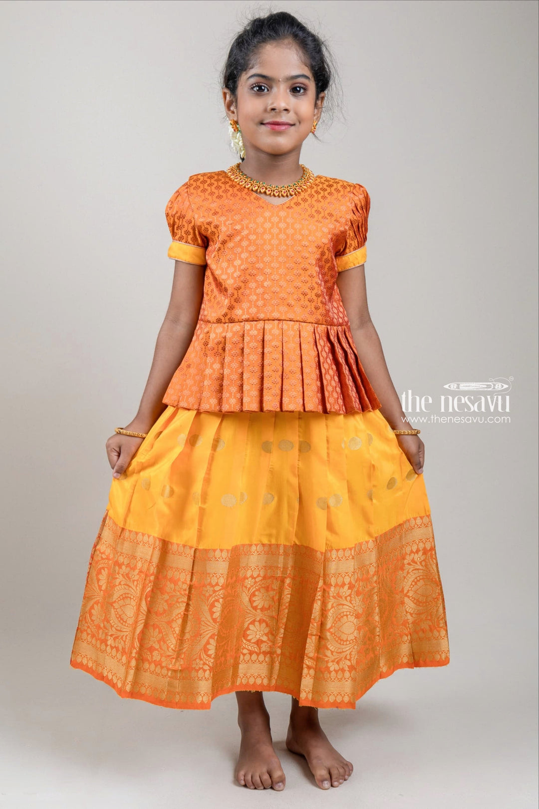 The Nesavu Pattu Pavadai Zari Floral Designer Brown Silk Peplum Blouse with Knife Pleated Yellow Silk Skirt for Girls Nesavu Zari Floral Designer Yellow Silk Peplum Blouse with Knife Pleated Yellow Silk Skirt for Girls | Shop at The Nesavu